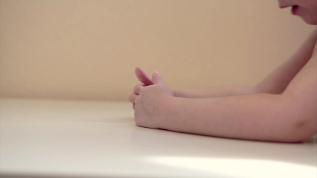 the child plays with wooden figures: shapes, numbers and colors. Details of the toy in the hands. Concept of development of fine motor skills, educational games, childhood, of, children's day, kinderg