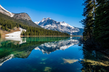 Fototapeta na wymiar Last vestages of winter hang onto Emerald Lake. Yoho National Park. British Columbia, Canada.