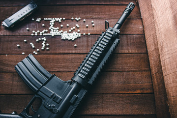 on boards is airsoft assault rifle, and scattered balls