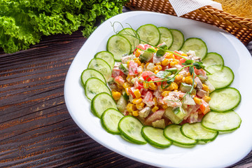 Fresh salad of vegetables and meat on wooden rustic background