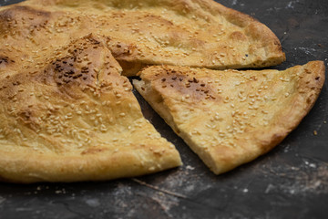 Tortilla with sesame seeds on a dark background