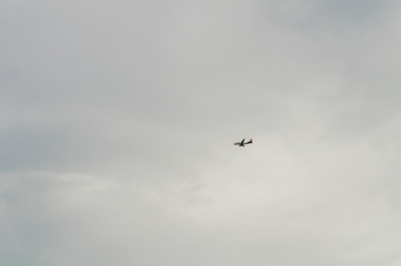 Airplane flying in a cloudy sky