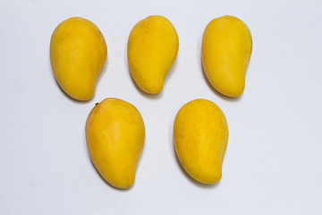 Bunch of yellow sweet mangoes on white background