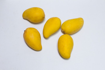 Bunch of yellow sweet mangoes on white background