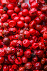 fragrant pink peppercorns on white acrylic background