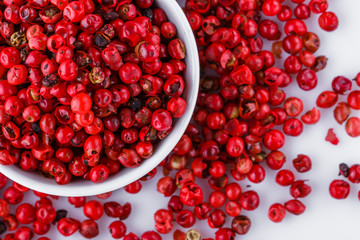 fragrant pink peppercorns on white acrylic background