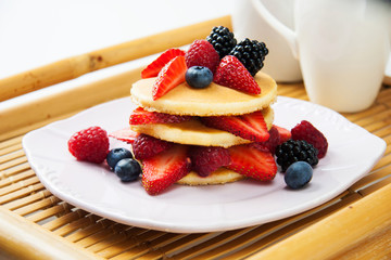 Ideal Sunday morning treat - brunch - delicious pancakes with fresh fruits.