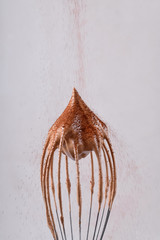 Whipped cream peak on the balloon whisk