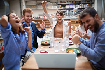 group of young adults having a video call in restaurant, celcebrating. technology, business partners, colleagues online, internet,