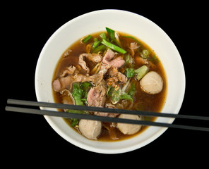 Close up Chinese clear soup and meatball and vegetables on white bowl