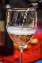 Serving champagne in a glass close up