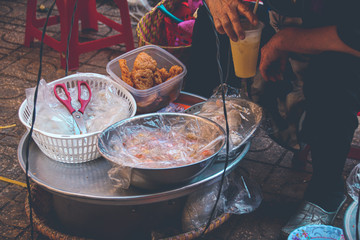 Vietnamese street food vendor selling sweets using the traditional carrying pole