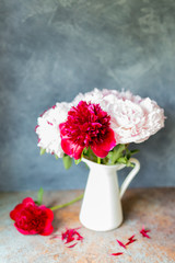 Vase with bouquet of beautiful peonies on table in room, close-up. Bloom. Peony. 
