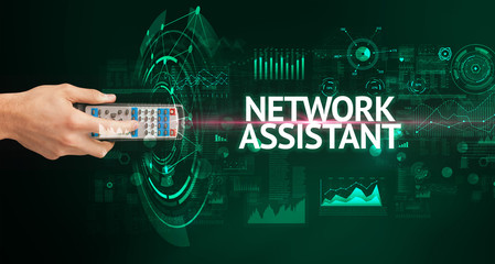 hand holding wireless peripheral with NETWORK ASSISTANT inscription, modern technology concept
