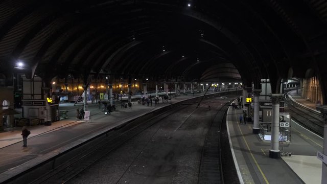 dark train station with bridge view of the platforms for crime police transport for london