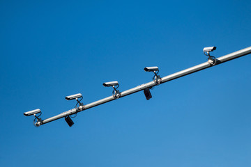 Five CCTV cameras mounted on the mast of the road post. 4 cameras are looking in the same direction for watching the road traffic & people safety. Last camera looks aside