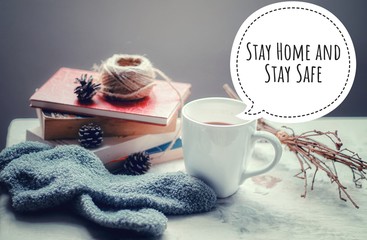 Conceptual still life and typography promoting safety and social distancing during covid-19 pandemic by staying at home