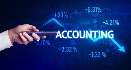 male hand holding wireless peripheral with ACCOUNTING inscription, modern business concept