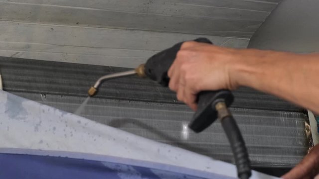 technicial worker use pressure pump gun for clean air condition
