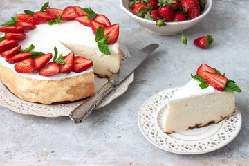 Homemade cheesecake with fresh strawberries and mint leaves