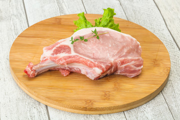 Raw pork bone steak over wooden