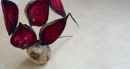 Different pieces of fresh, raw, red beet in section in unusual composition on white background.