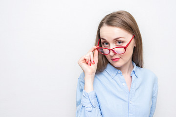 Playful secretary woman took off red glasses, portrait, white background, copy space