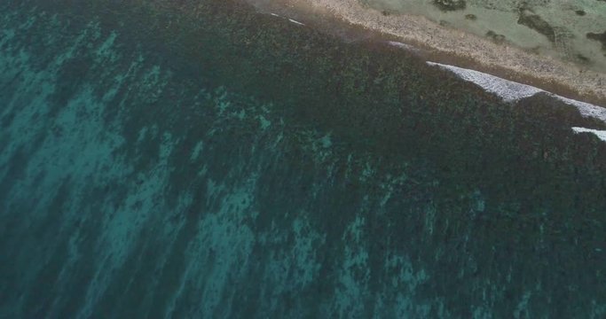 
Dominican Republic aerial shot. Sea, ocean, waves, blue water, lanaft, corals, a beautiful flight on a drone parallel to the water.