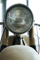 Fragment of an old motorcycle. Headlight