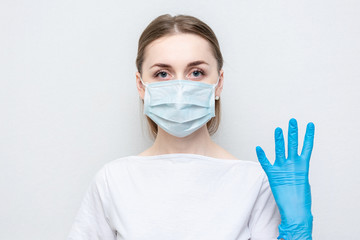 Doctor or nurse in medical mask and gloves show sign four, portrait, close up