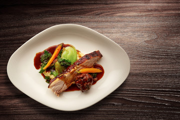 Overhead shot of a gourmet plate of sliced roast pork