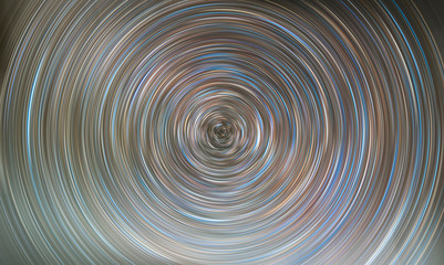 Fototapeta na wymiar Beautiful starry sky with star trails orientation on the north star. Space background. Abstract long exposure background.