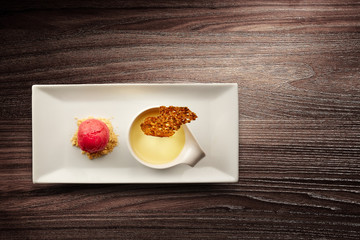 Plate of creme brulee on wooden background