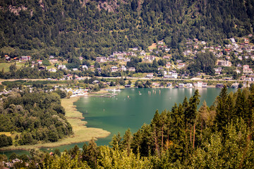 Fototapeta na wymiar Panorama from Ossiacher lake with the mountain Gerlitzen in the background in sunny weather in Carinthia, Austria in Europe