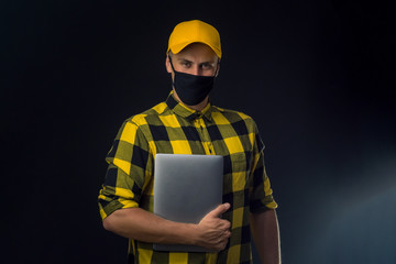 Fototapeta premium portrait of a construction worker in mask on black background