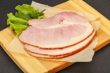 Sliced pork belly over board