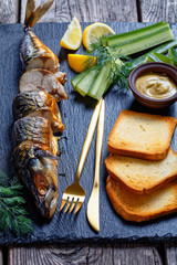 Homemade hot smoked mackerel with toasts, close-up