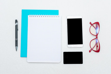 Notebooks, pen, red women's glasses, phone and business card, white background, top view, copy space