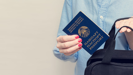 Girl puts passport of a citizen of Belarus, women's hands, cropped image, close up, white...