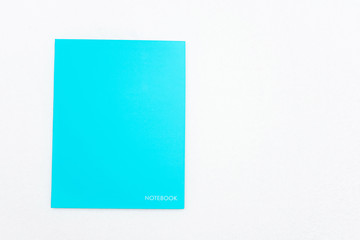 Blue notebook on white background, top view, copy space