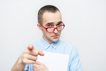 Teacher man looks reproachfully at the camera and points a finger at you, a portrait, white background