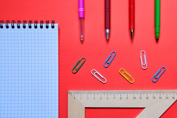 School stationery and space for text on red background. The view from the top.