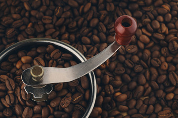 Vintage coffee grinder steeped in roasted arabica coffee beans