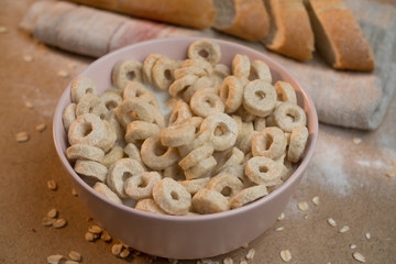 Close-up a full plate of cereal rings drenched in milk. The concept of home comfort at breakfast