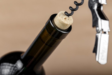 bottle of wine with corkscrew in a cork