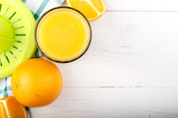 fresh oranges and a glass of juice