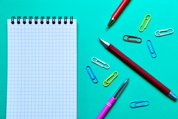 School stationery and space for text on a blue background. The view from the top.