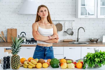 Dieting concept .Diet. Beautiful Young Woman near in the kitchen with healthy food. Fruits and Vegetables.