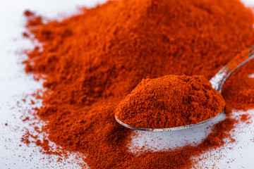 fragrant ground paprika on a white acrylic background