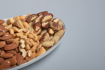 Three kinds of roasted nuts on plate. Healthy fats for health
